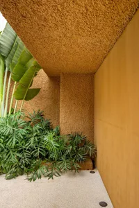 Entryway with terra-cotta walls and porcelain floor