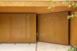 Metallic sliding gates in a contemporary exterior design.