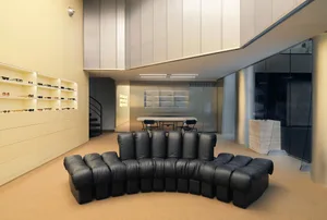 Modern retail interior featuring a sunwear shop with metal and leather accents.