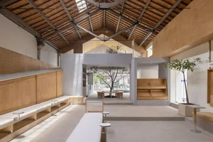 A minimalist interior space featuring wooden finishes and open-plan design.