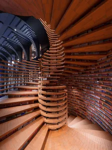 An industrial-style library with wooden architectural elements.