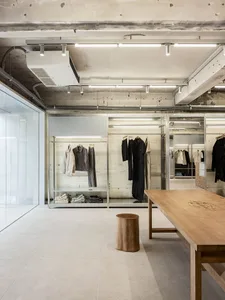 Modern commercial interior featuring metal and concrete elements for clothing retail