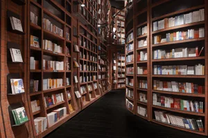 A modern, minimalist library space featuring brick shelving filled with books of various sizes and colors.
