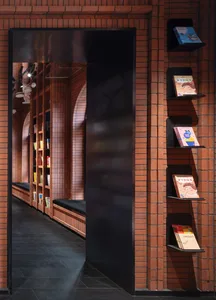 A modern library with brick walls and reading benches.