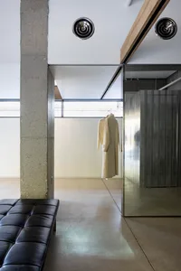 A modern clothing store featuring concrete and glass materials.