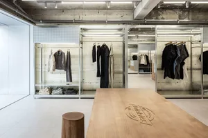 Modern retail store featuring a clothing shop with retro-inspired clothing, showcasing metal and concrete design elements.