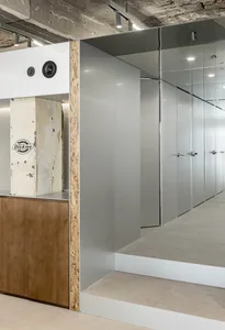 Modern office closet with metallic gray PVC paneling and concrete ceiling