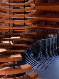 A library interior featuring cascading brick shelves and a wave-like structure.
