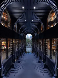 An industrial-style library with metal bookshelves and a mirrored floor.