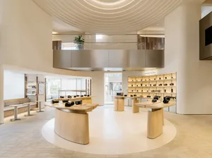 A modern retail store featuring minimalist design and wooden display surfaces.