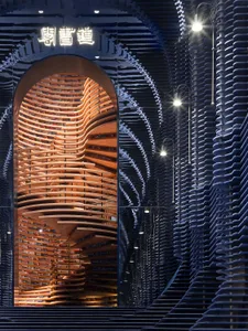 Library interior with wooden shelving and curved architectural design.