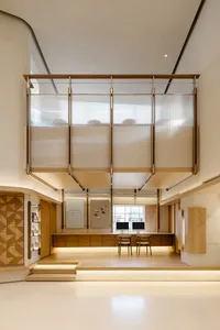 A minimalist office space featuring wooden furnishings and a modern design.