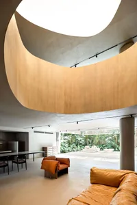 A modern residential space featuring a mix of concrete, wood, and metal materials.