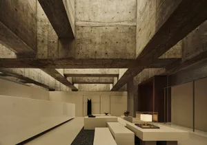 A modern exhibition space with concrete walls and ceiling beams, featuring a minimalist design with white benches and lightin