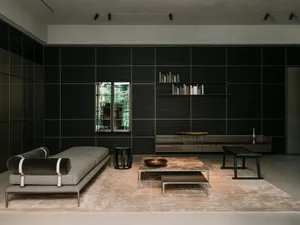 Modern minimalist living room featuring metal, glass, and black wood materials.