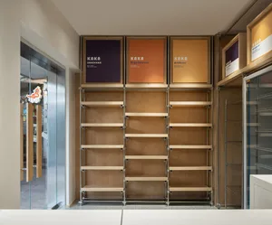 Modern retail shop interior with wooden shelves and branding graphics.