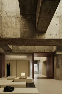 Minimalist retail store entrance with concrete walls and ceiling beams