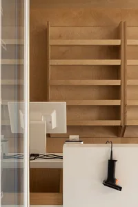 Minimalist retail storefront featuring wooden shelves.