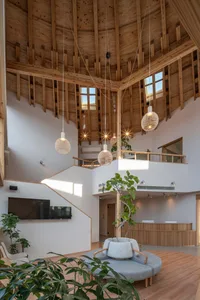 A modern industrial lobby with wooden beams and pendant lights.