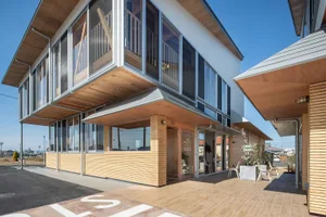 Modern building with metal-clad windows and balcony exterior.