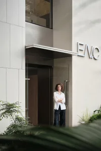 A modern building entrance with glass doors and a white exterior.