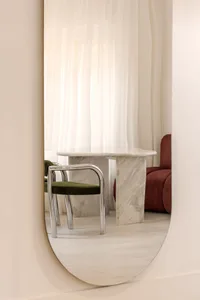 A modern marble table in a living room setting.