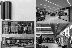 Modern retail store interior with concrete walls and clothing racks