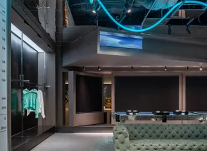 Modern retail space with concrete flooring, glass walls, and metal accents