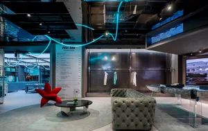 A modern retail storefront featuring concrete, glass, and metal materials.