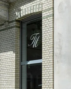 A modern brick facade with the letter 'M' displayed.