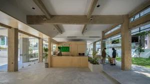 Interior view of a modern coffee shop featuring concrete walls and floors.