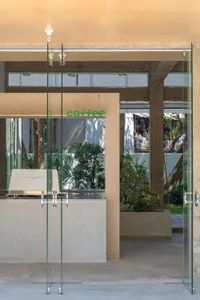 Modern coffee shop interior featuring contemporary concrete and glass materials.