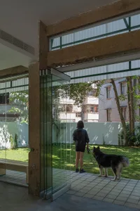 A modern interior design featuring glass and concrete materials.