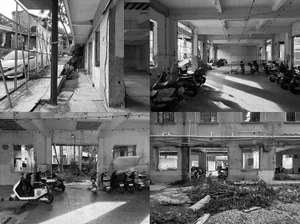建築內混凝土停車區，停放多輛機車，搭配裸露橫樑與工業設計元素。