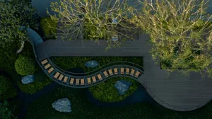 A curved wooden boardwalk surrounded by native plants and green roofs.