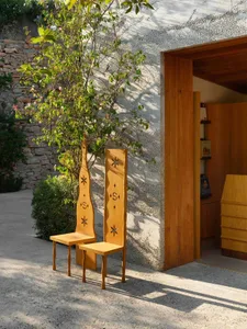 Modern architecture featuring wooden flooring with a tree in the background.