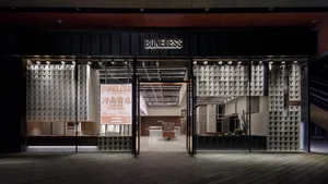 A modern commercial space with illuminated glass panels and industrial design elements.