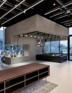 A modern office space featuring a concrete and wooden desk, with a minimalist design.