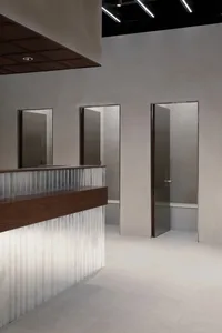 Modern interior design featuring metallic surfaces, wood accents, and concrete elements