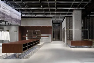 A contemporary retail storefront featuring concrete and steel materials.