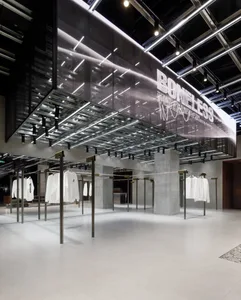 Modern retail shop featuring glass, concrete, and metal materials.