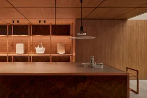 Modern retail storefront with wooden walls, marble counter, and minimalist design.