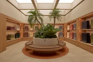 A modern retail storefront featuring wood and plant accents