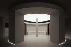 Modern minimalist living room with white and concrete surfaces, highlighted by a central column and circular light fixture.