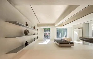A minimalist retail storefront with concrete walls and a sleek, modern design.