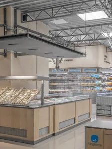 Industrial-style retail store featuring metal shelving units and wooden displays.