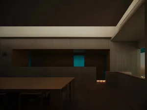 簡約辦公空間，地板與牆面皆為木板材質，設有辦公桌與座椅。