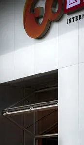 A modern building facade with a steel entrance.