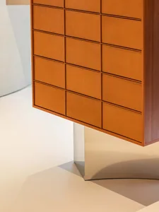 A modern minimalist cabinet with orange leather panels.