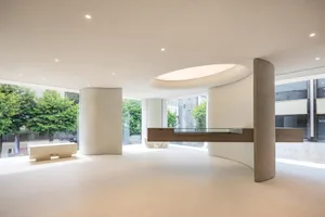 An image of a modern office space featuring minimalist design with concrete and wood elements.